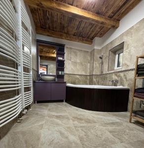 a large bathroom with a tub and a sink at FÜGE - Füredi füge terasz in Balatonfüred