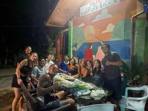 a group of people standing around a table in front at mama hostel Bed & Breakfast in El Nido