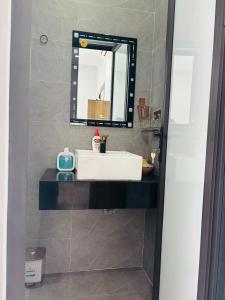 a bathroom with a white sink and a mirror at Sunrise Homestay in Danang