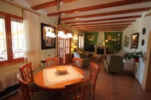 a dining room and living room with a table and chairs at Finca Cantares - holiday home with private swimming pool in Benissa in Benissa