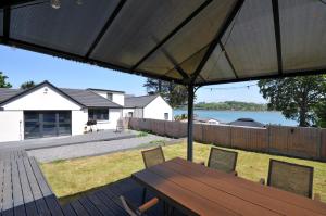 a patio with a wooden table and chairs at The Mooring in Bideford