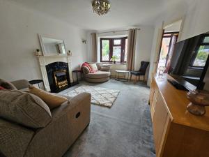 a living room with a couch and a fireplace at Carey House Long Stays Free Parking and WI-FI in Swindon