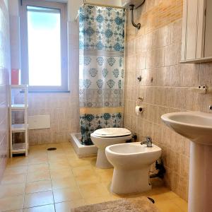 a bathroom with a toilet and a sink at Villa S.Antonio in Ascea