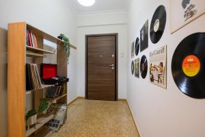 a hallway with a door and some records on the wall at Patision cinema apartment in Mesochórion