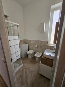 a bathroom with a toilet and a sink at Luna Rossa in Ladispoli