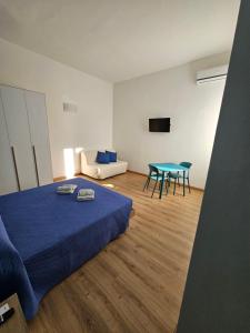 a bedroom with a bed and a table and a couch at Luna Rossa in Ladispoli