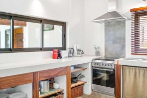a kitchen with a counter top and a stove at Vayu - Eco Chic House Tamarin in Tamarin