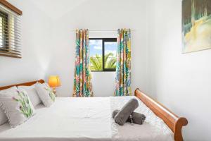 a bedroom with a bed and a window at Vayu - Eco Chic House Tamarin in Tamarin +26 photos