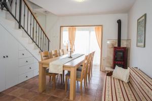 a dining room with a wooden table and chairs at Villa Suzy Lux in Sutivan