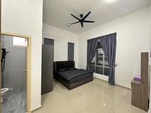 a bedroom with a bed and a ceiling fan at Xiang Homestay in Padang Serai
