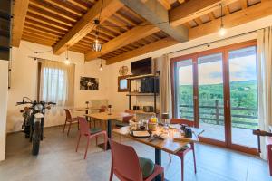 a living room with a table and chairs and a motorcycle at Agriturismo Ca' Belluccio in Santa Maria del Piano