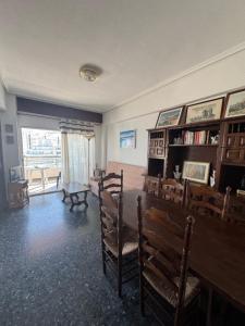 a living room with a dining room table and chairs at Résidence El Prado in Cullera +7 photos