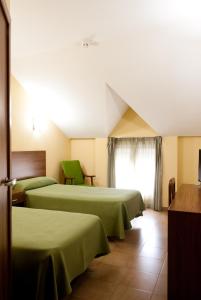 Säng eller sängar i ett rum på Hotel Hidalgo Quijada