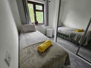 a room with two beds and a mirror at Carey House Long Stays Free Parking and WI-FI in Swindon
