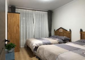 Ліжко або ліжка в номері Boxianyuan Three-Bedroom Apartment