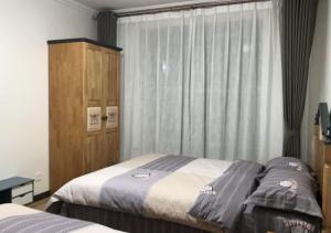 Ліжко або ліжка в номері Boxianyuan Three-Bedroom Apartment