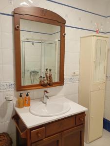 ein Badezimmer mit Waschbecken und Spiegel in der Unterkunft Espectaculares vistas a la Ría de Aldán in Bueu