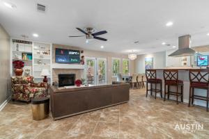 a living room with a couch and a fireplace at Pool Hot Tub Parking EV Charger 4BR 3BA N Austin Getaway by Austin Vacay in Austin