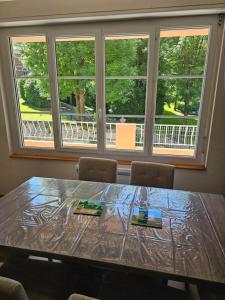 a dining room table with chairs and a window at Évasion à Luz in Luz-Saint-Sauveur +17 photos