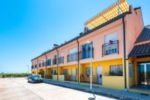 a building with a car parked in front of it at Duplex Torre La Sal Magic World in Cabanes