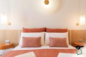 a bedroom with a large bed with two pillows at Hotiday Apartments Torre Lapillo in Porto Cesareo