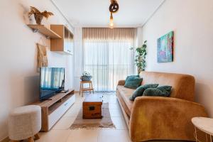 a living room with a couch and a television at Duplex Torre La Sal Magic World in Cabanes