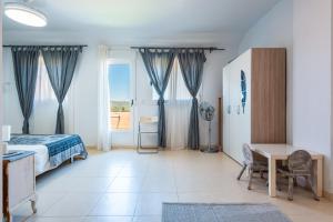 a bedroom with a bed and a desk and a window at Duplex Torre La Sal Magic World in Cabanes