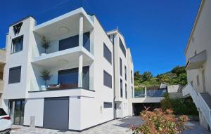 a large white building with windows on top of it at Double pleasure - two apartments with sea views and pool in Komarna