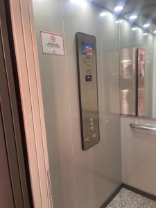a elevator with a remote control on a wall at Apartamentos Palma del Río CAROLA in Linares