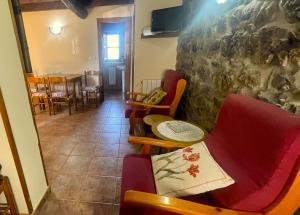 a room with chairs and a table and a dining room at Casa El Collau I in La Frecha