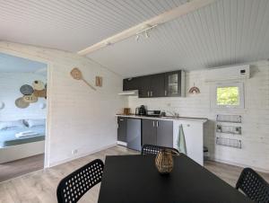 a kitchen and dining room with a table and chairs at Къщички Морски Светулки in Sinemorets