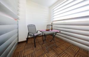 a small table and two chairs in a room at Lovely Apartment In Zadar With Wifi in Zadar