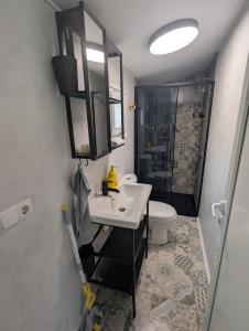 a bathroom with a sink and a toilet and a shower at Къщички Морски Светулки in Sinemorets +34 photos