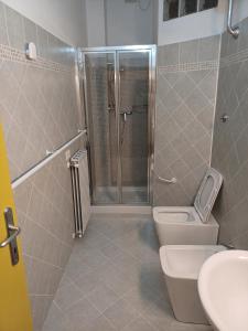 a bathroom with a shower and a toilet and a sink at Il Caminetto in Montecastrilli