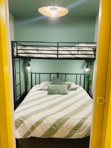 a bed in a room with a bunk bed at Bulle d amour in Granville