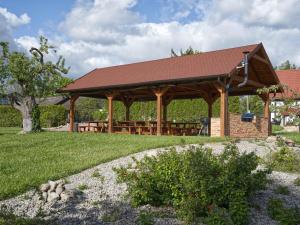 a pavilion with a picnic table in a park at Uroczysko Lutówko in Sępólno Krajeńskie
