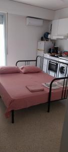 a bed in a small room with a kitchen at Acropolis View Studio in Monastiraki in Athens