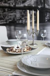 a table with a plate of food and wine glasses at Apartment Babic in Split