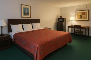 a hotel room with a large bed and a desk at Key Inn Roseville in Roseville