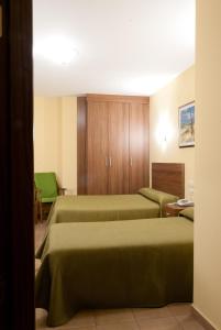 Postel nebo postele na pokoji v ubytování Hotel Hidalgo Quijada