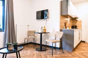 a small kitchen with a table and chairs in a room at Stylish Studio with Balcony, Near Tilburg Station in Tilburg