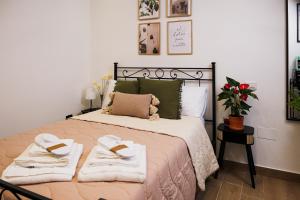 a bedroom with a large bed with towels on it at Il Giardino di Sole in Bari