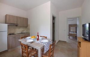 a kitchen and dining room with a table and chairs at 1 Bedroom Lovely Apartment In Ricadi in Ricadi