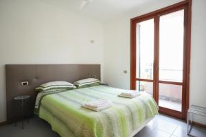 a bedroom with a large bed and a window at Blue Horizon Apartment- 5 Terre in Monterosso al Mare