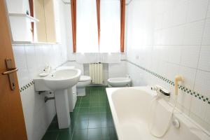 a bathroom with two toilets and a sink and a tub at Blue Horizon Apartment- 5 Terre in Monterosso al Mare +14 photos