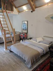 a bedroom with two beds and a staircase in it at Woodland Lodge in London