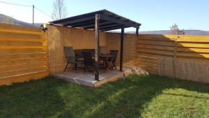 a patio with a table and chairs under a roof at Castra Holidays GmbH 