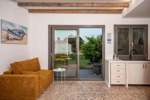 a living room with a couch and a table at Seaside Villa Angel - Samos Cozy Getaway in Kámpos