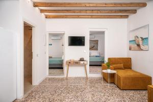 a living room with a couch and a table at Seaside Villa Angel - Samos Cozy Getaway in Kámpos