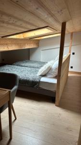 a bedroom with a bunk bed with a wooden ceiling at Roof top Moutain view direct access Morzine Avoriaz in Montriond